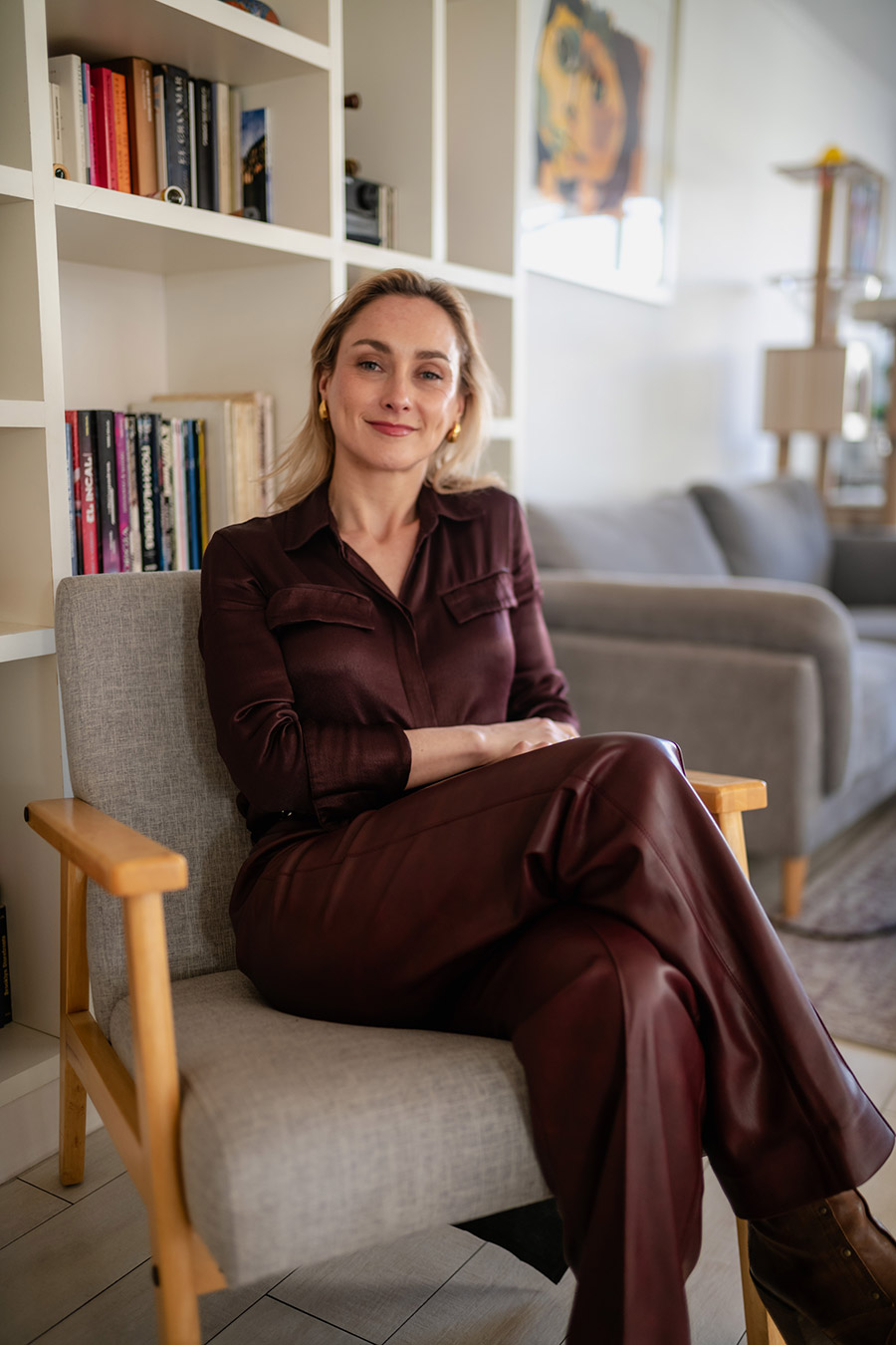 Retrato profesional de mujer en interior con fondo de librero, ideal para web y marca personal